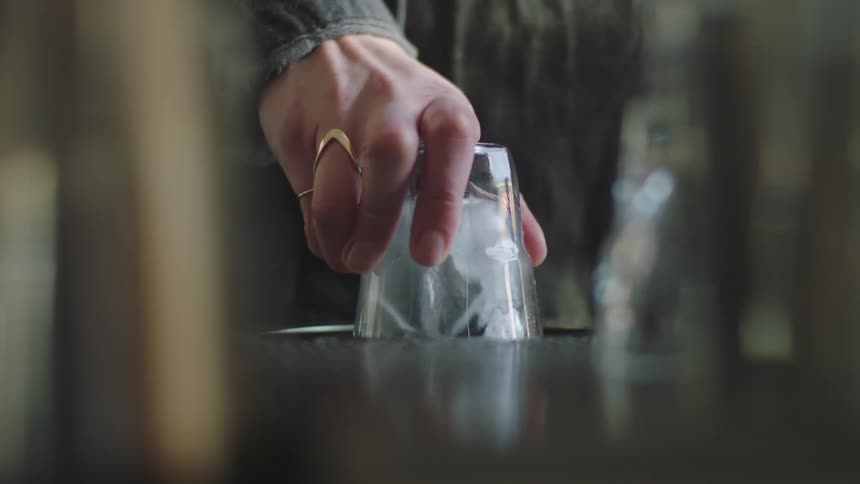 A worker washes a glass