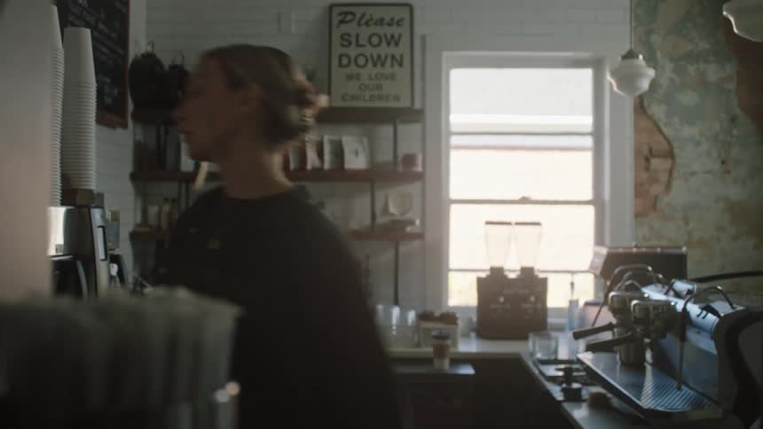 Woman working in the kitchen of a cafe