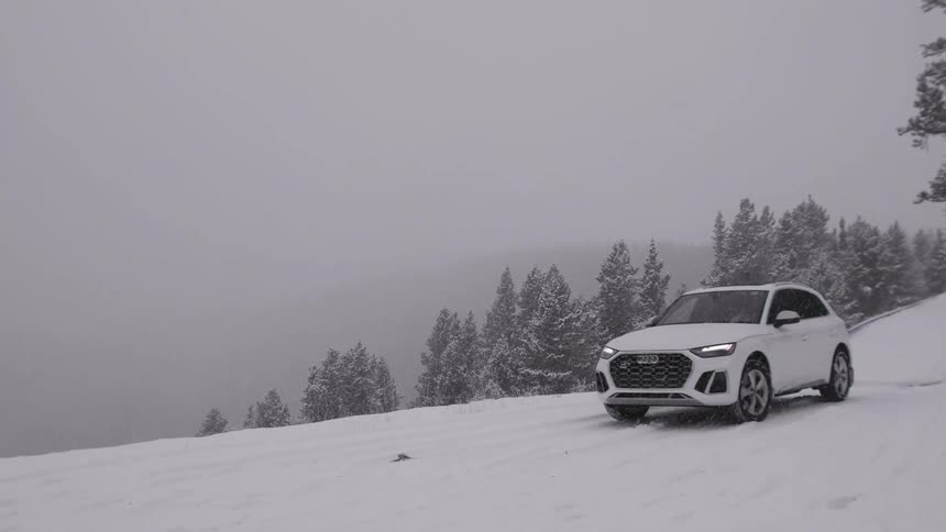 A car drives in snow and fog
