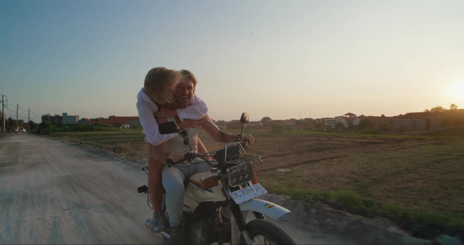 Aman and woman ride on a motorcycle together