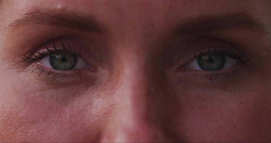 A woman slowly opens her eyes