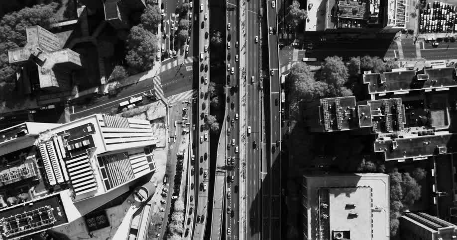 Aerial view of a busy urban intersection with several roads and buildings around it