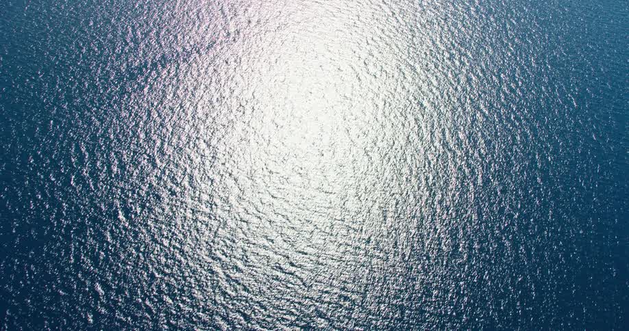 A vast expanse of water with sunlight reflecting off the surface