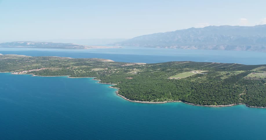 Aerial panorama of an island surrounded by a blue sea