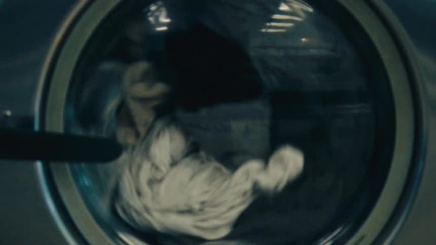 The lansophie washing machine has a transparent window revealing a load of laundry being washed