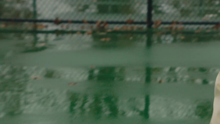 Woman shooting with a racket on a tennis court