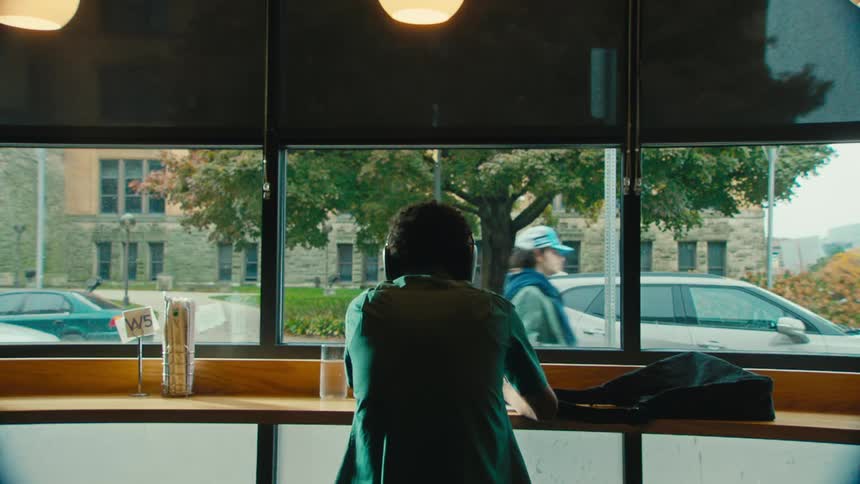 A man listens to his headphones in the restaurant