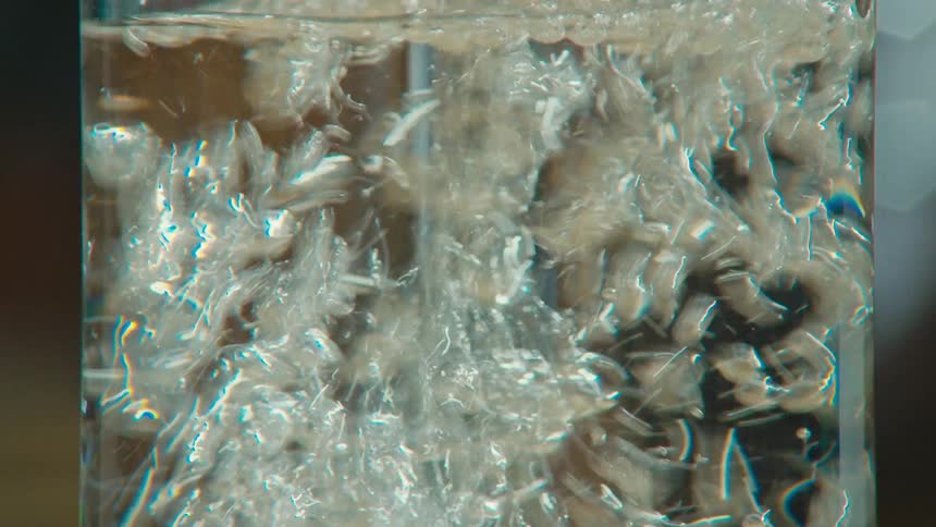 A clear liquid poured into a glass