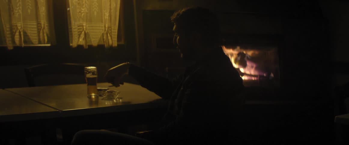 Man sitting at a table smoking a cigarette