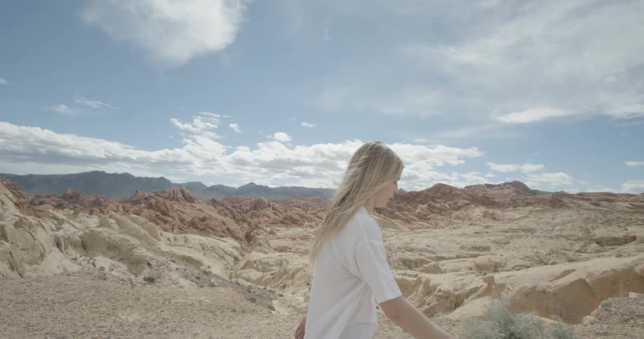 A woman walks through the desert