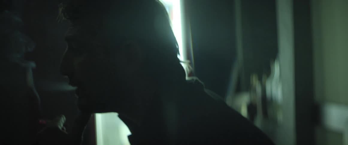 A man sits and smokes a cigarette