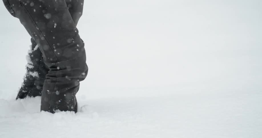 Person trudging through high snow