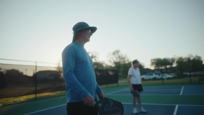 Two people on a court playing pickleball