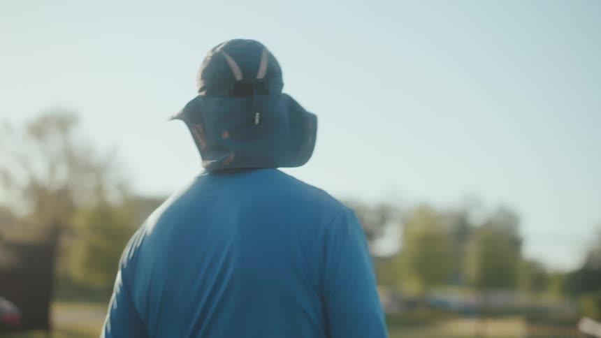 Elderly people playing pickleball on a tennis court