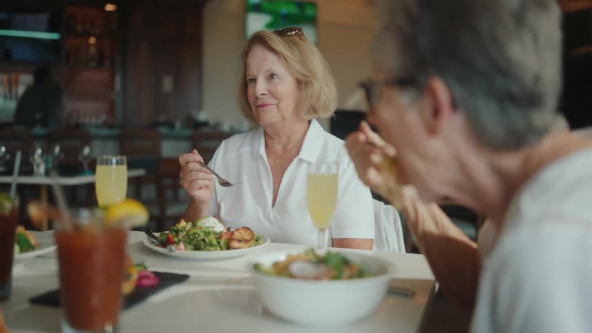 Woman talks while eating out with friends at a restaurant