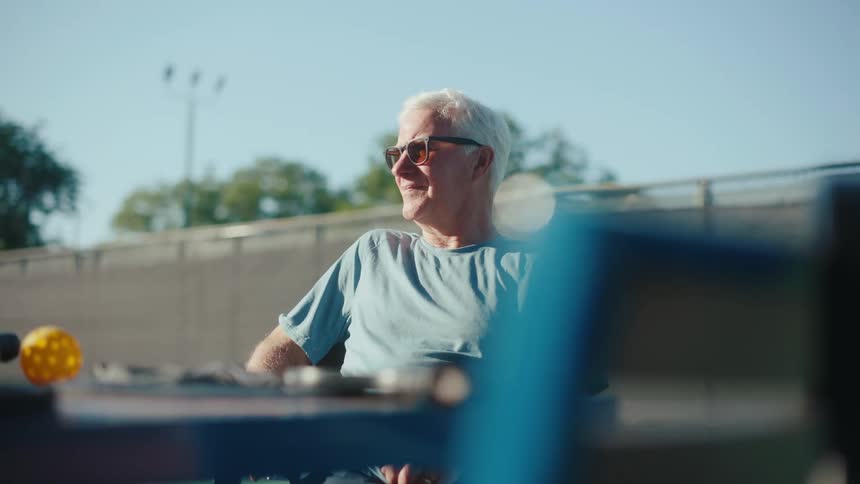 Man with sunglasses sitting outdoors
