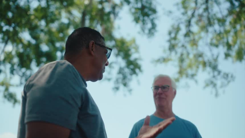 People in an open air environment talking and smiling