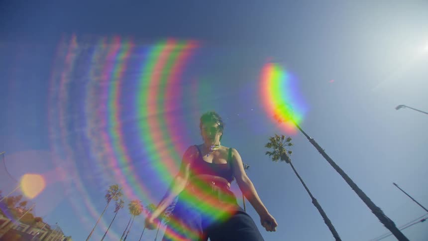 A woman is dancing on a sunny day