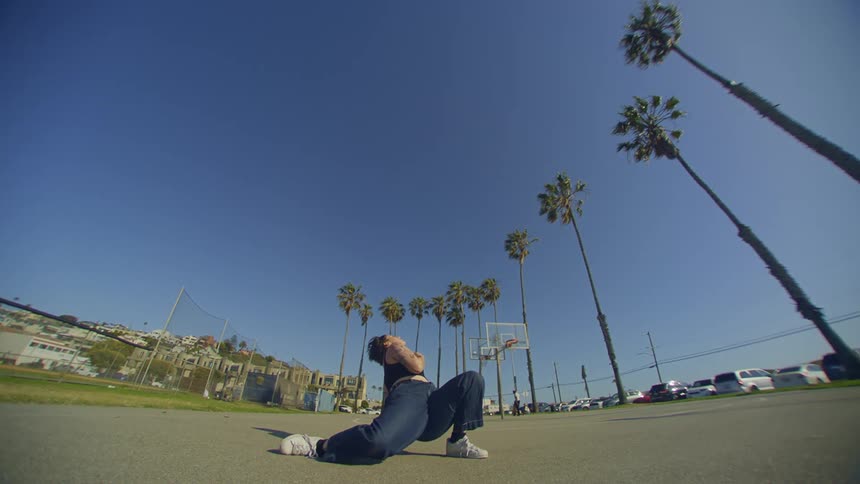 Dancer woman dancing in jeans in a park