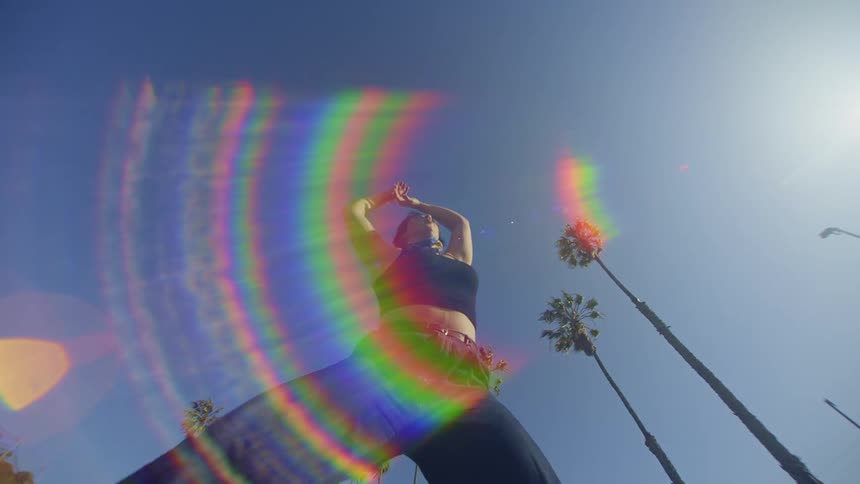 Woman on a cloudless blue sky day dancing