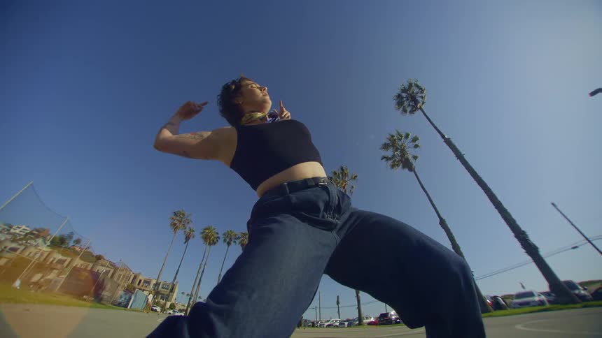 A woman is dancing on a sunny day