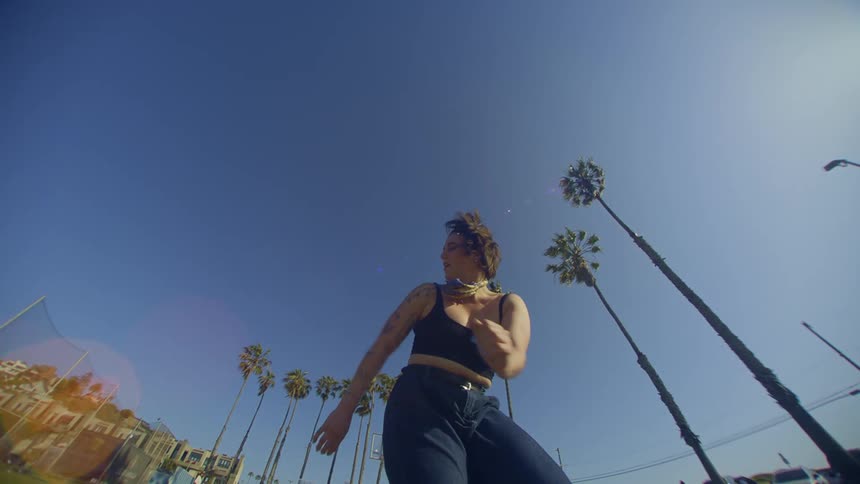 Woman in jeans dancing in a park