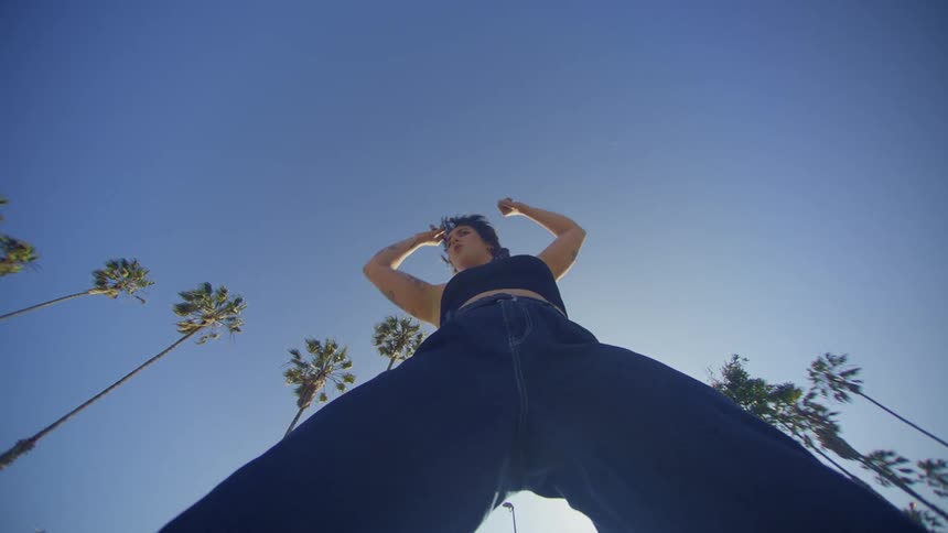 A woman is dancing on a sunny day