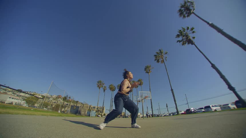 Woman in jeans dancing in an openair park