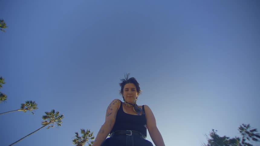 Top view of a woman bending down while in an openair environment with sunlight