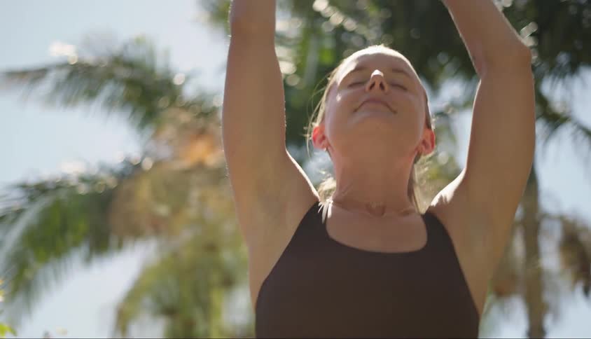 Woman with happy facial expression stretching her arms