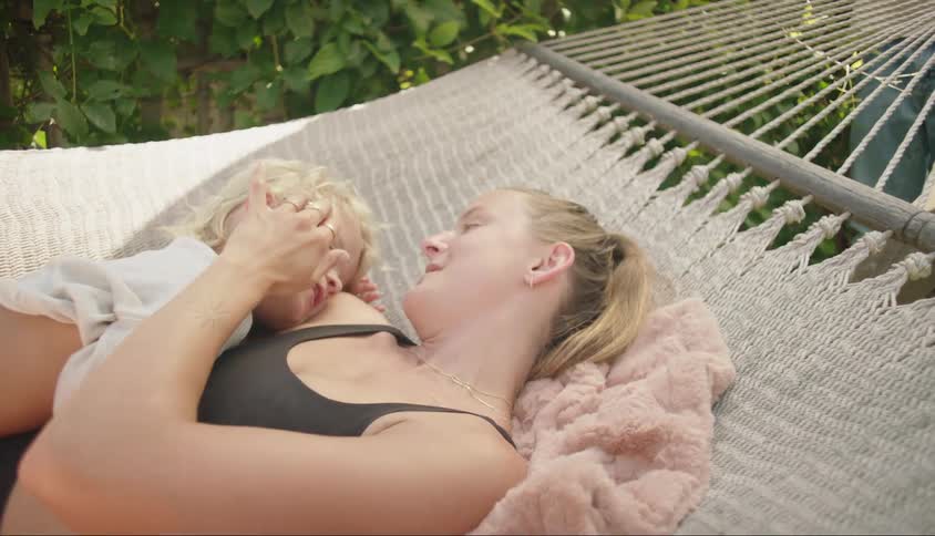 Mother lying in a hammock with her little boy