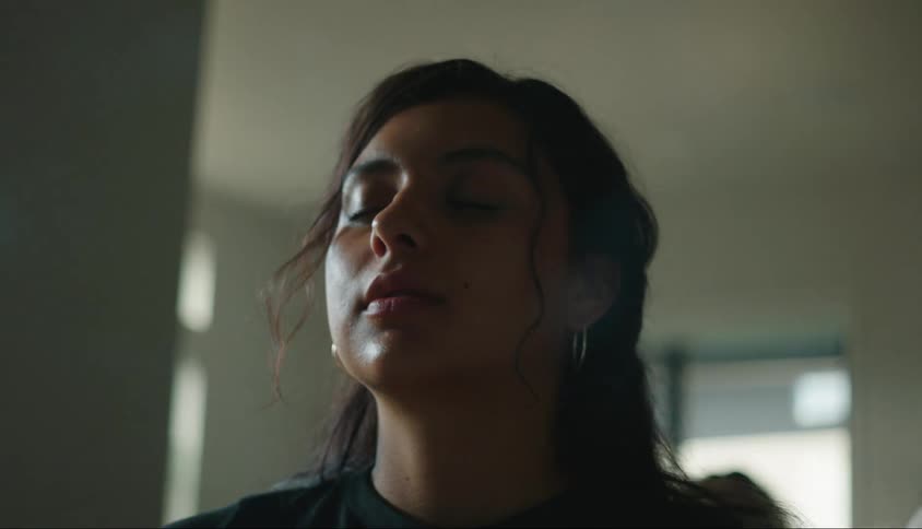 Portrait of a woman with her eyes closed and smoke surrounding her