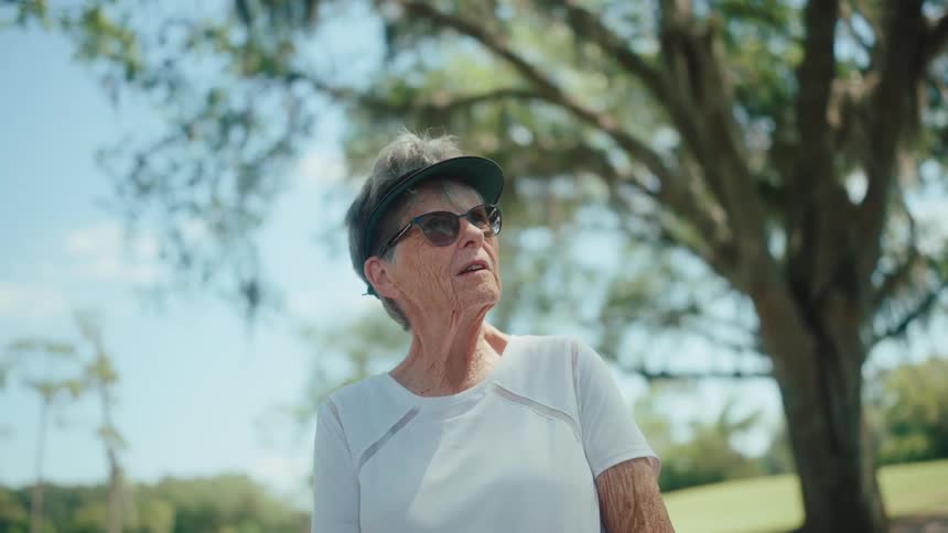 An older woman is talking in the park