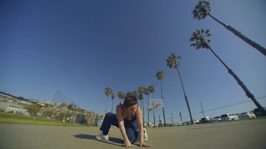 Woman in jeans outdoors dancing