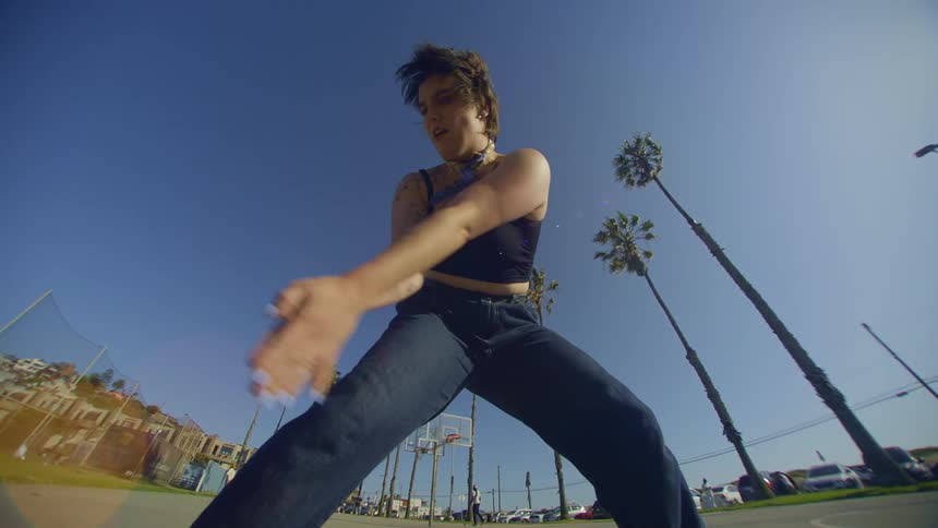 Young woman in an openair park dancing