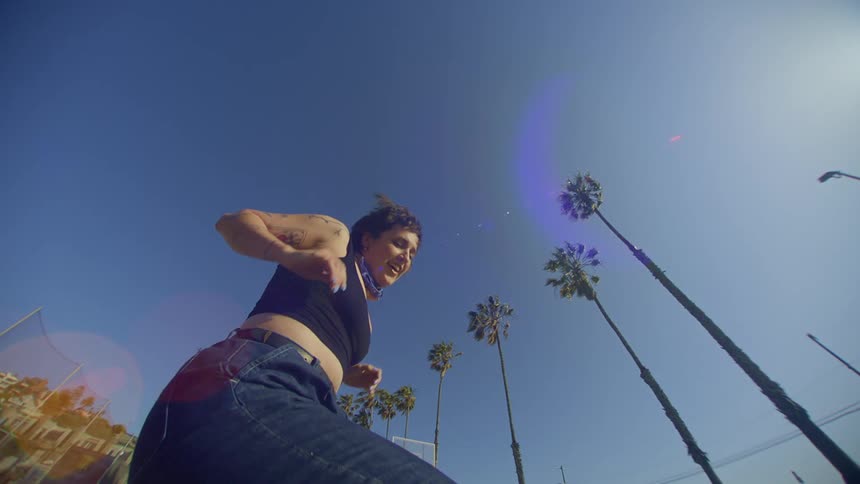 Woman in jeans dancing in an outdoor setting
