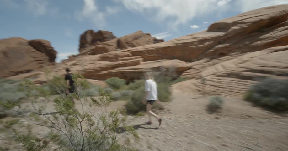 People hike in a desert