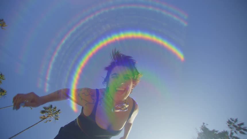 Portrait of a smiling woman outdoors with reflected sunlight