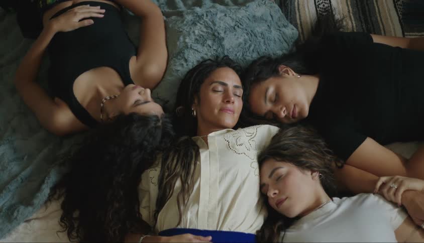 Woman smiles while lying down together with other women