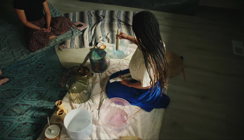 Woman sitting preparing a ritual indoors