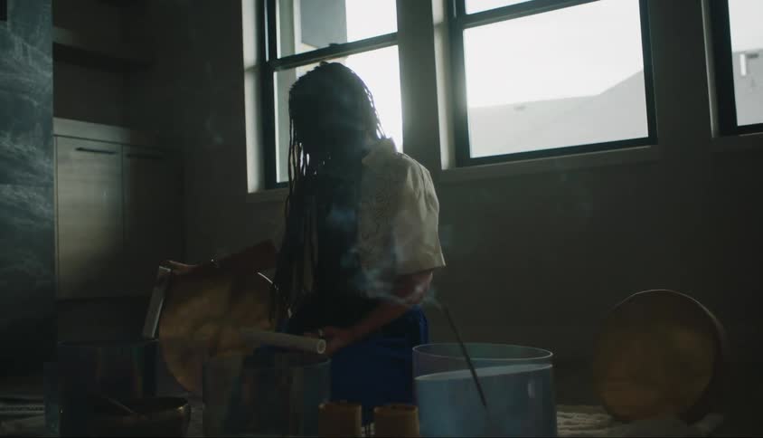 Woman sitting concentrated using essences that emit smoke in ritual