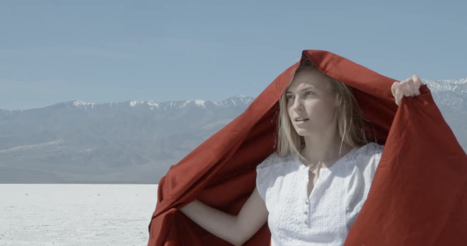 A woman puts a sheet over her head