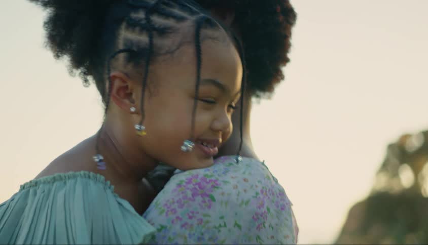 A mother is hugging her daughter