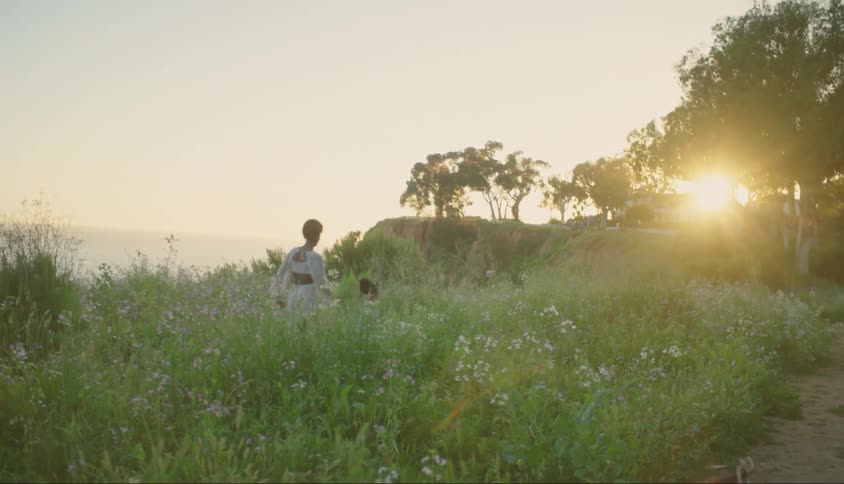 Mother and daughter running in a flowery field