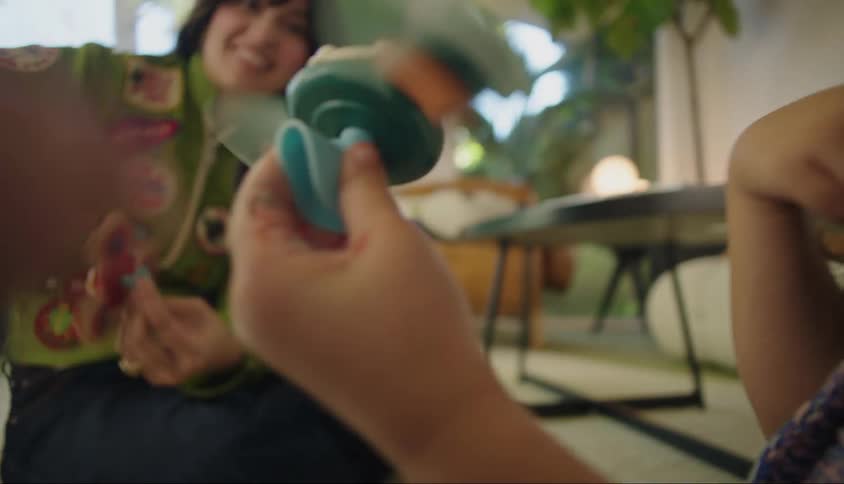 A mother and daughter spin their toy