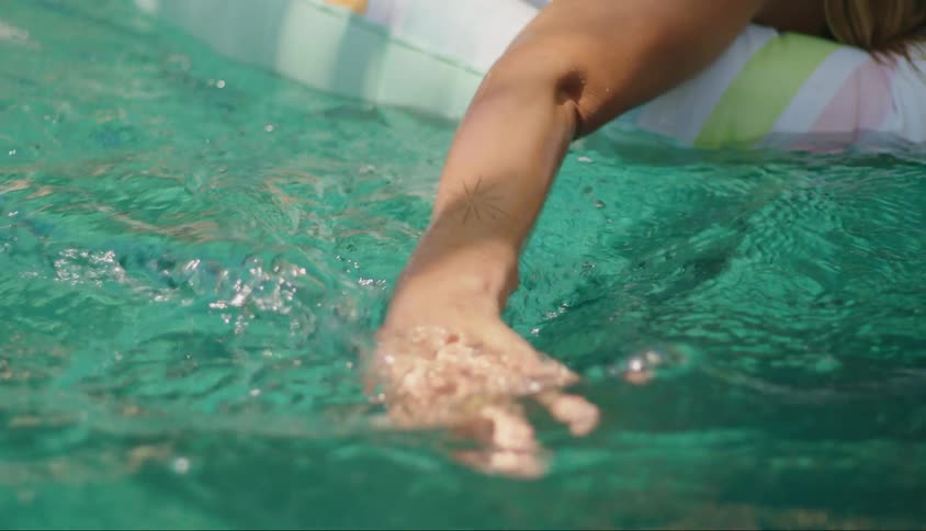 A woman floats in the pool