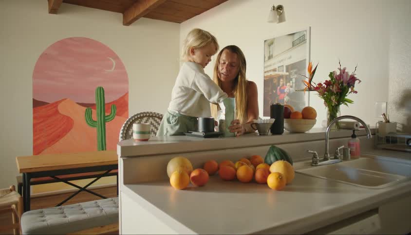 Mother in the kitchen preparing something together with her little son