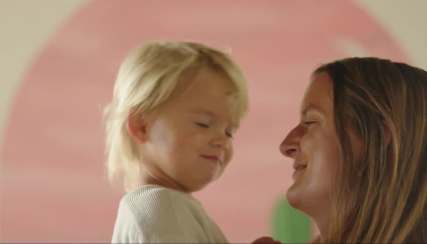 Portrait of a mother giving a kiss to her little son