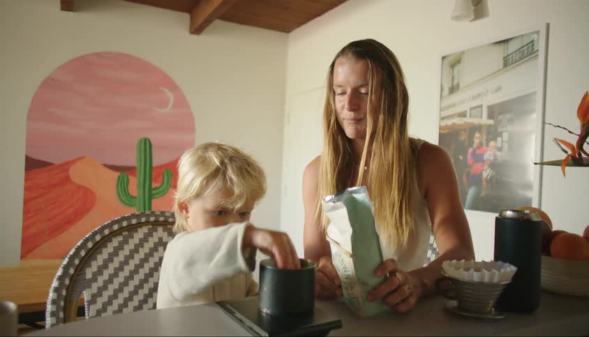 Little boy helping his mother prepare coffee