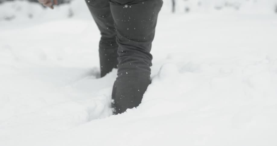 Person trudging through some deep snow as seen from their hips down